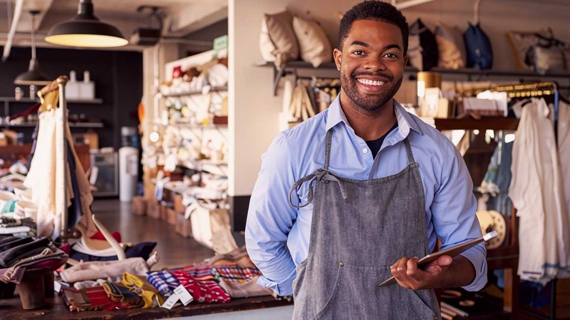 A business manager poses inside a shop. A business manager poses inside a shop.