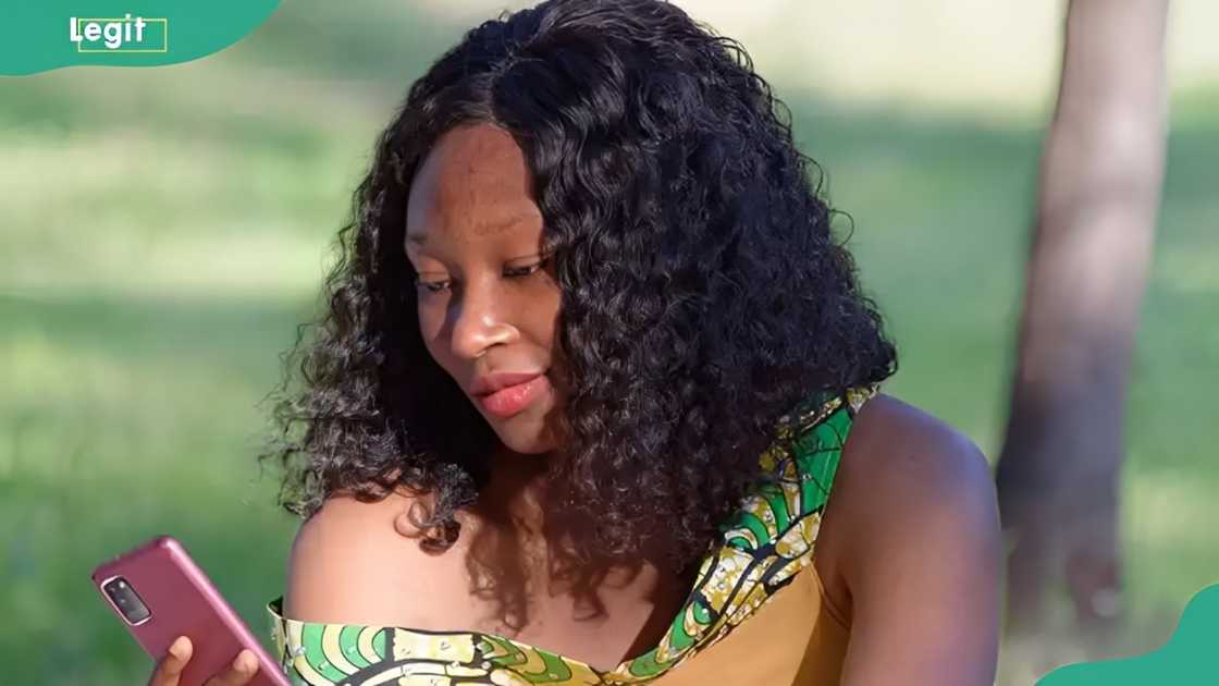 A lady checks her phone A lady checks her phone