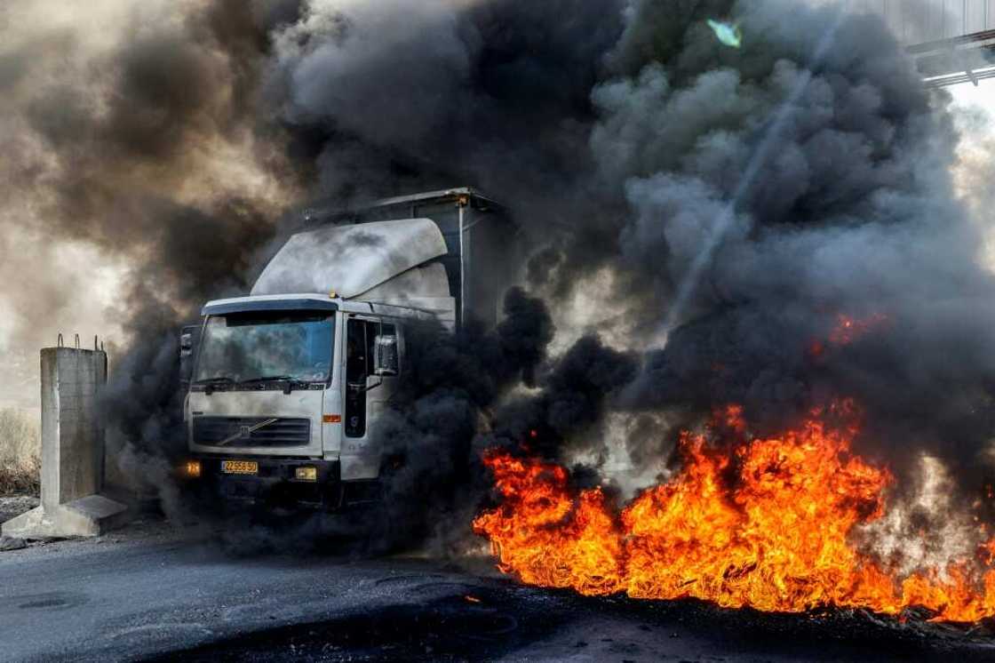 A truck headed towards Nablus drives past tyres set on fire by protesters in the occupied West Bank on November 1: the United Nations says recent months have been the deadliest period in years in the West Bank A truck headed towards Nablus drives past tyres set on fire by protesters in the occupied West Bank on November 1: the United Nations says recent months have been the deadliest period in years in the West Bank