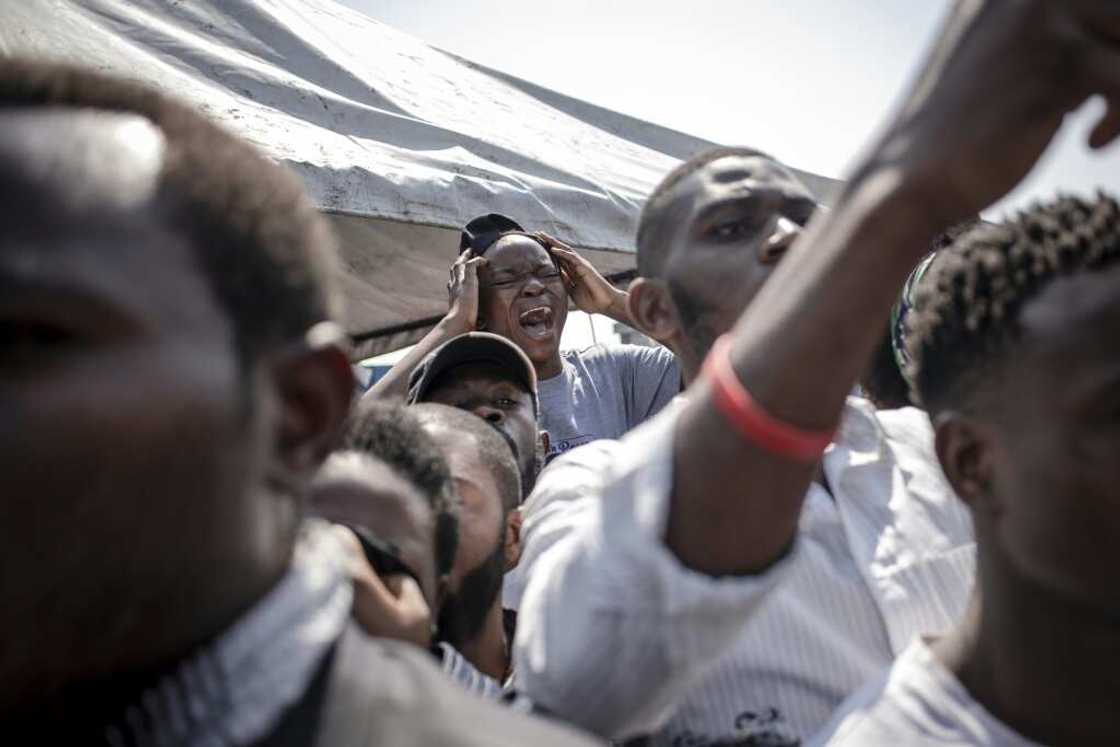 A girl mourns the death of her brother at Friday's funeral