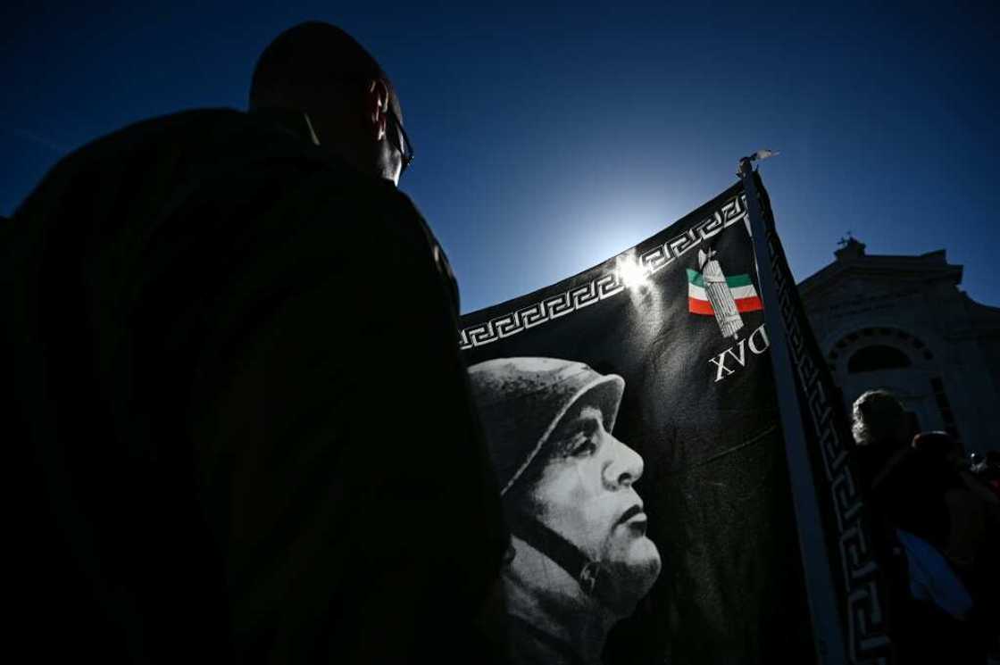 A participant holds a flag during a rally marking the centenary of the March on Rome which ushered in fascism