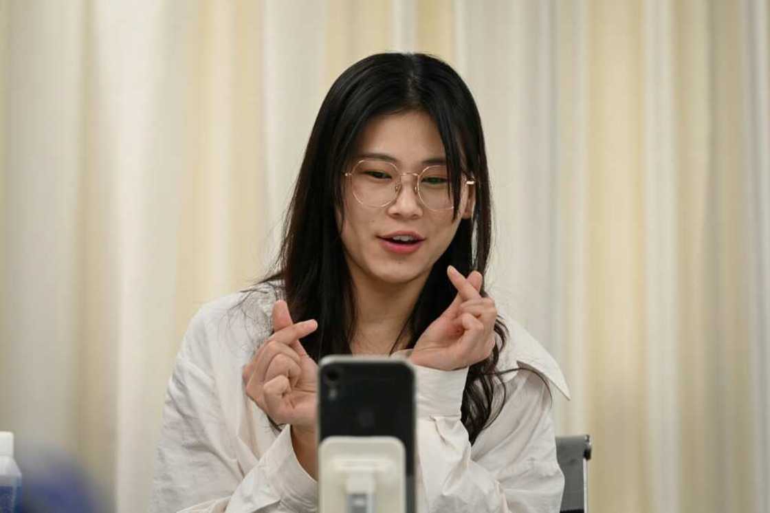 Instructor Wang Yaxuan uses her phone to livestream on TikTok at Mede Education Technology's e-commerce school in Guangzhou Instructor Wang Yaxuan uses her phone to livestream on TikTok at Mede Education Technology's e-commerce school in Guangzhou