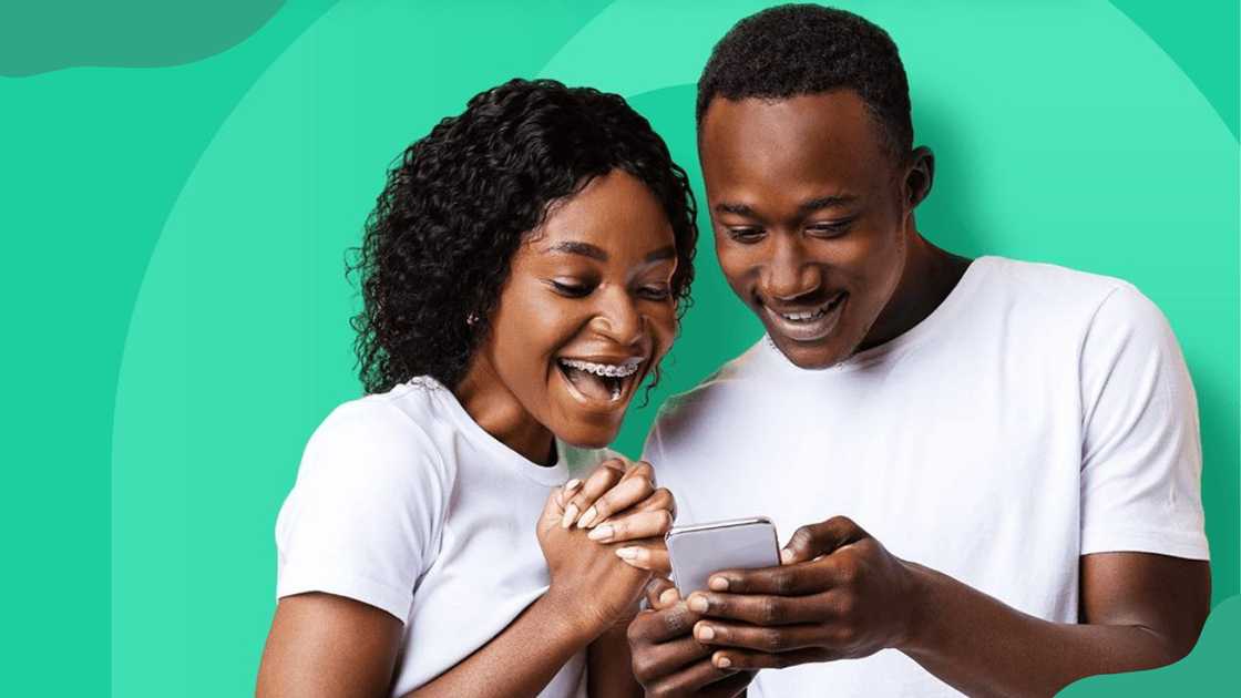 A young woman and man looking at a phone. A young woman and man looking at a phone.