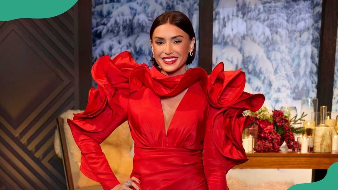 Bronwyn Newport in striking red dress with festive backdrop. Bronwyn Newport in striking red dress with festive backdrop.