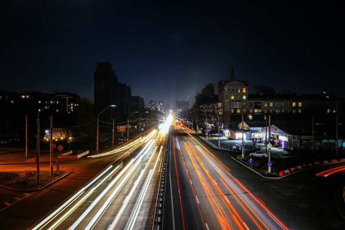 Cars drive during a blackout in Kyiv