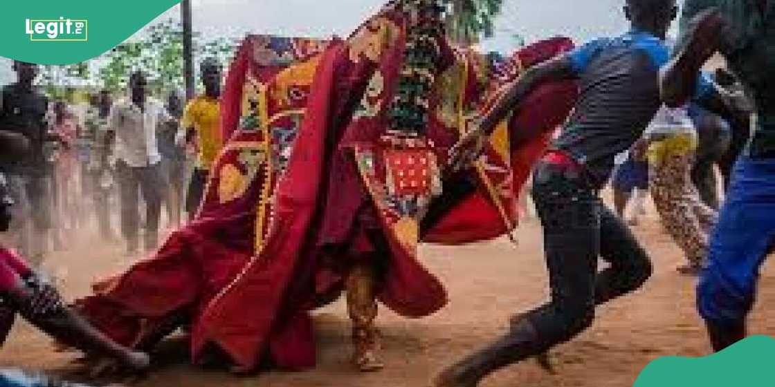 Egungun chasing a boy Egungun chasing a boy