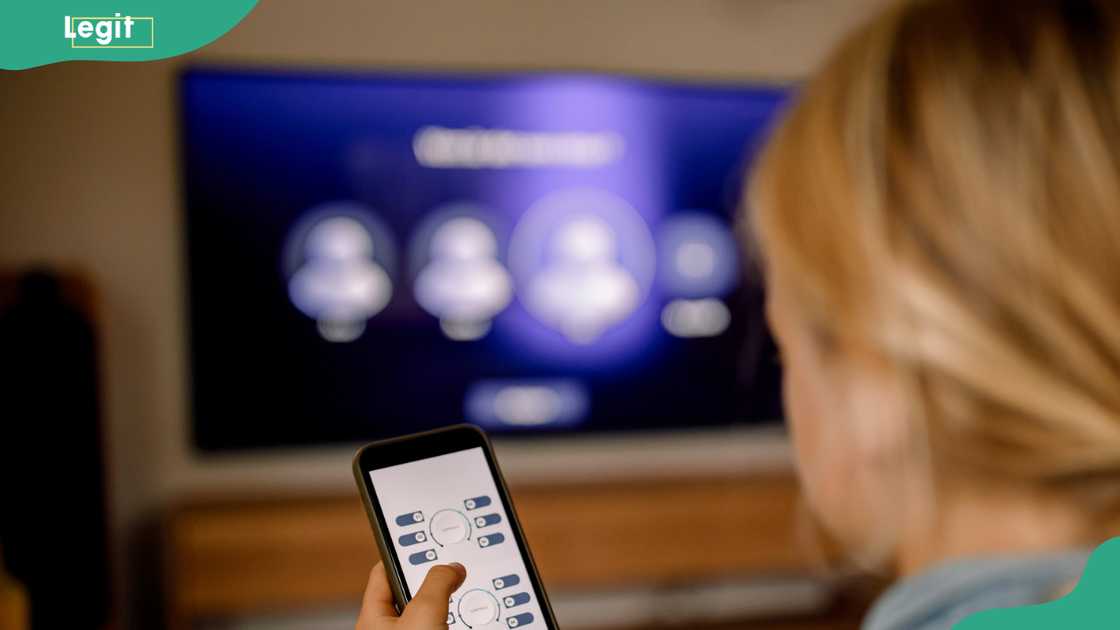 A person trying to connect their phone to a smart TV A person trying to connect their phone to a smart TV