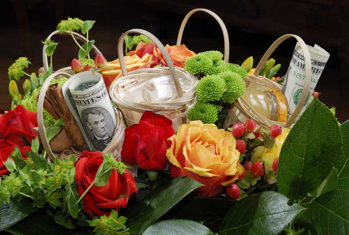 Colorful bouquet with baskets and dollar bill Colorful bouquet with baskets and dollar bill