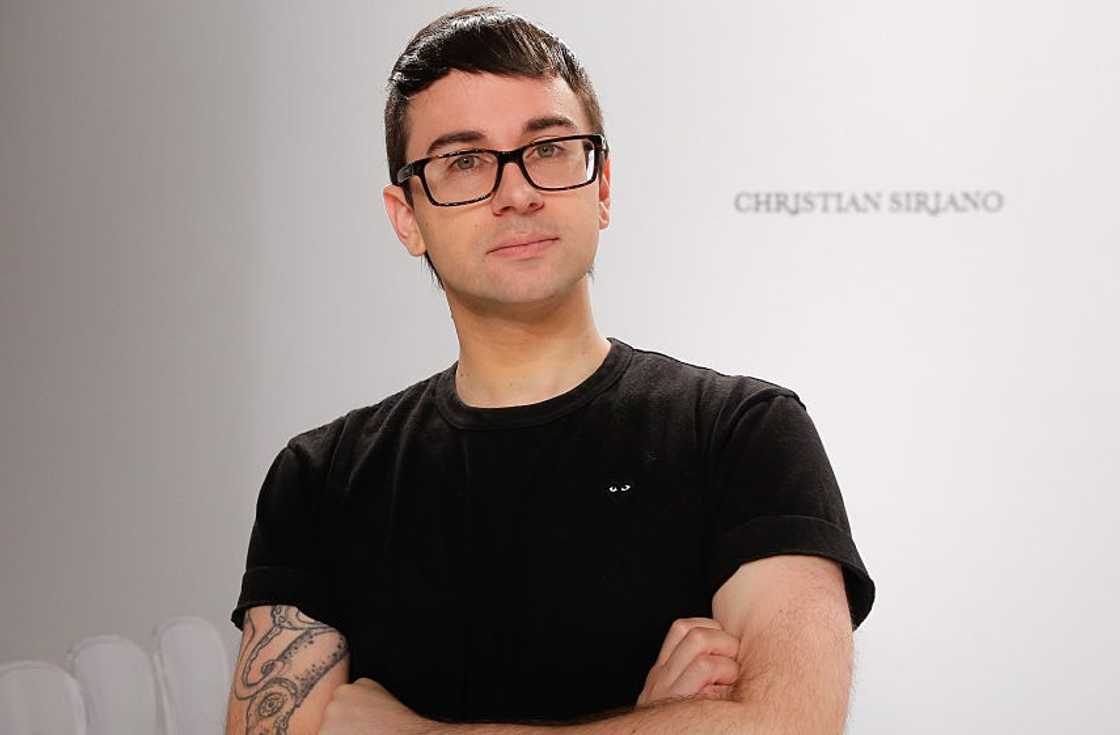 Christian Siriano poses on a runway