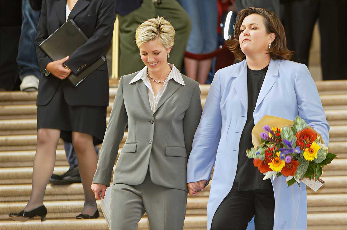 Rosie O'Donnell and Kelli Carpenter walk down a flight of stairs after their wedding Rosie O'Donnell and Kelli Carpenter walk down a flight of stairs after their wedding