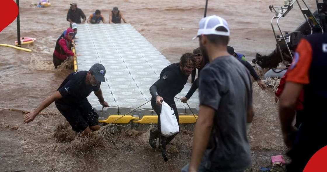Volunteers take back equipment from Lake Guaiba as a storm brews in Porto Alegre, Rio Grande do Sul state, Brazil, on May 8, 2024. Volunteers take back equipment from Lake Guaiba as a storm brews in Porto Alegre, Rio Grande do Sul state, Brazil, on May 8, 2024.