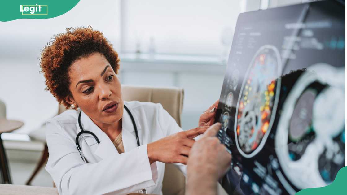 A neurosurgeon with a patient in the office for a consultation. A neurosurgeon with a patient in the office for a consultation.