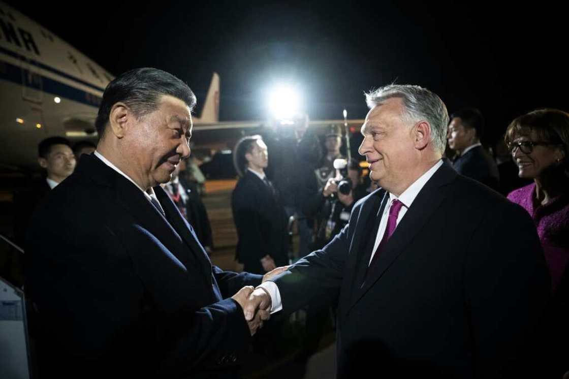 Chinese President Xi Jinping (L) is greeted by Hungarian Prime Minister Viktor Orban (R) at the airport Chinese President Xi Jinping (L) is greeted by Hungarian Prime Minister Viktor Orban (R) at the airport