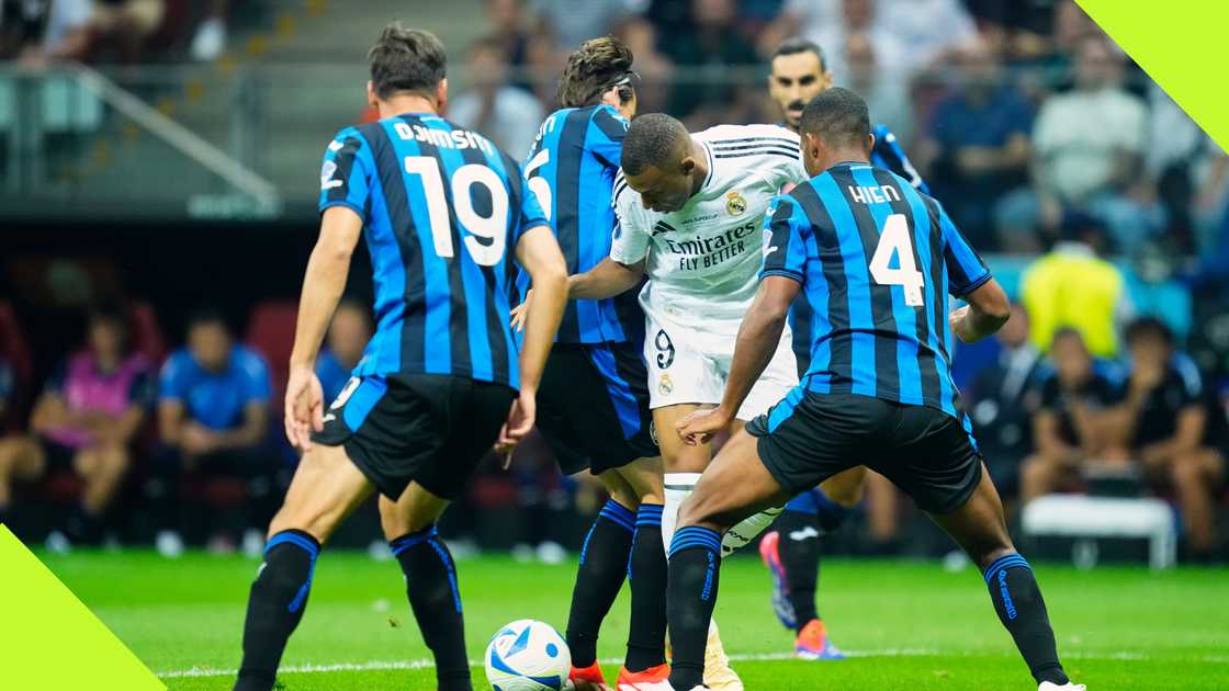 Kylian Mbappe tries to wriggle away from a sea of Atalanta defenders during Real Madrid's UEFA Super Cup triumph in Warsaw, Poland, on August 14, 2024. Photo by NurPhoto.