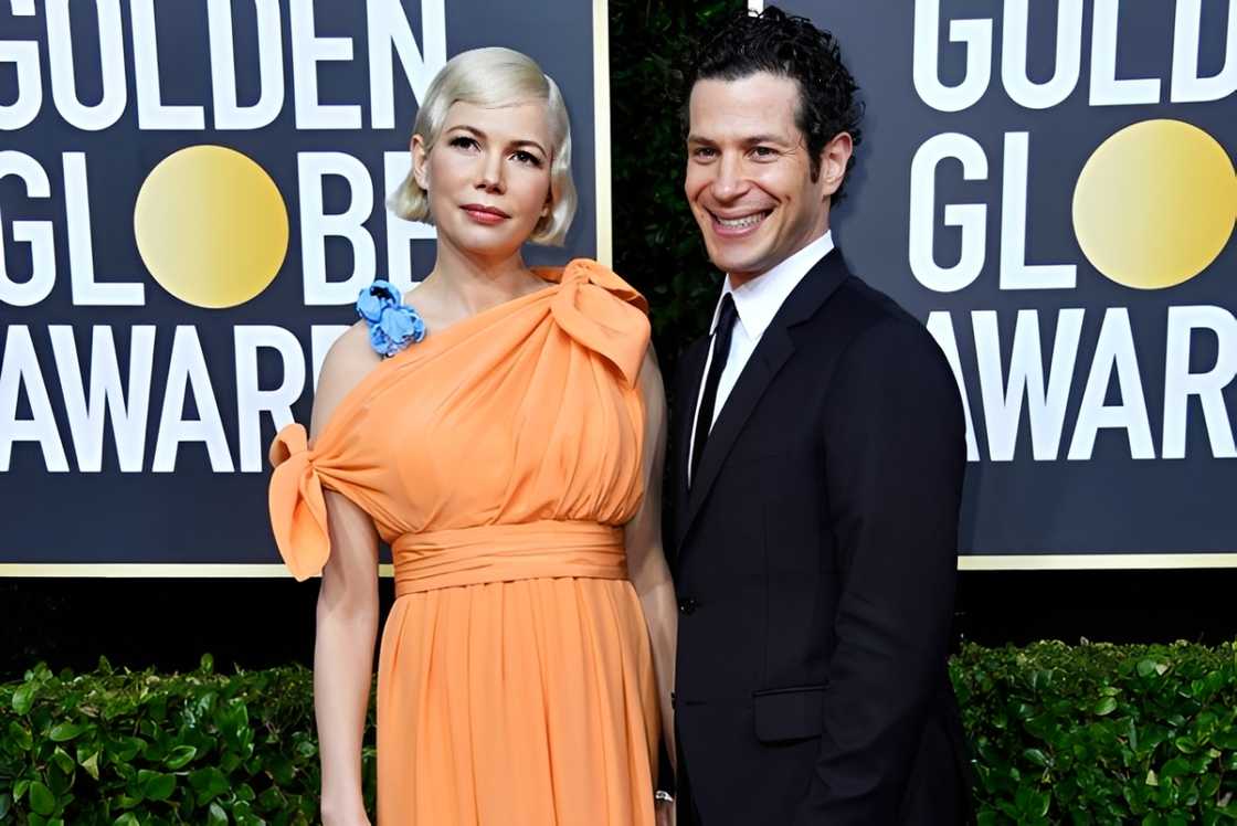Michelle Williams posing on the red carpet with Thomas Kail Michelle Williams posing on the red carpet with Thomas Kail