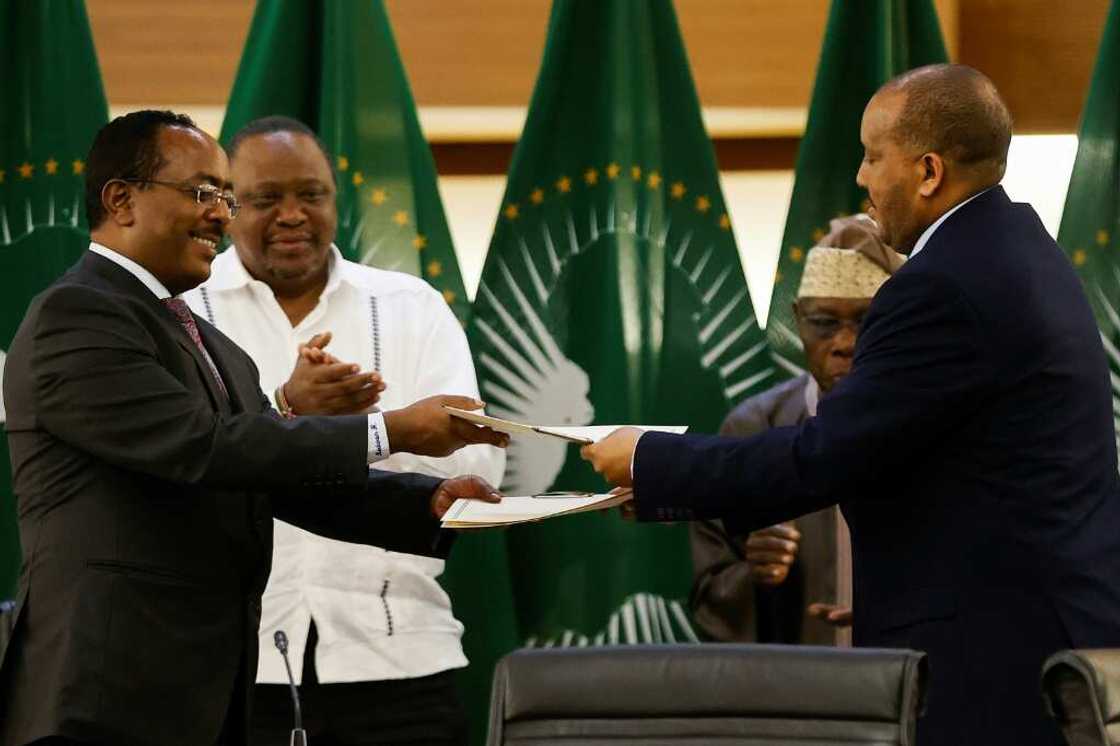 Ethiopian government representative Redwan Hussein (left) and Tigrayan delegation leader Getachew Reda seal the deal in Pretoria Ethiopian government representative Redwan Hussein (left) and Tigrayan delegation leader Getachew Reda seal the deal in Pretoria