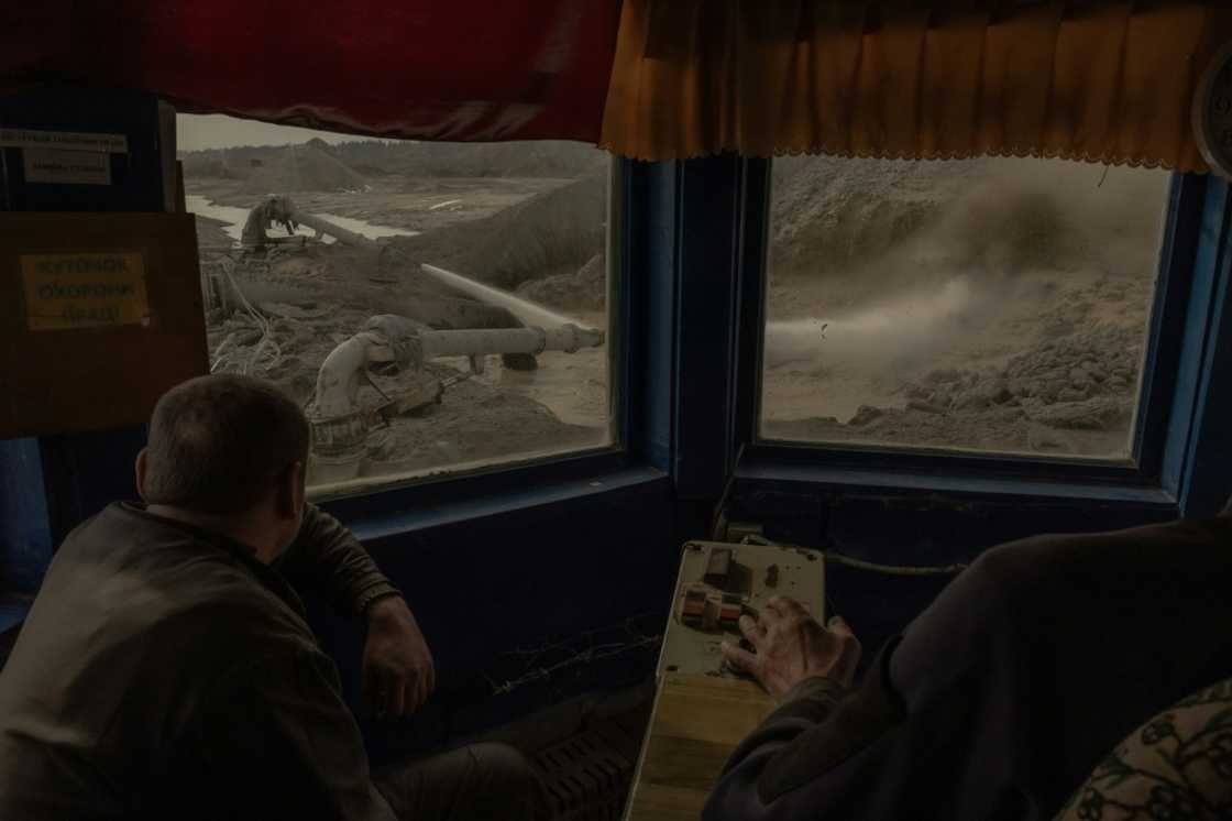 Workers operate machinery at an open-pit titanium mine in central Ukraine Workers operate machinery at an open-pit titanium mine in central Ukraine