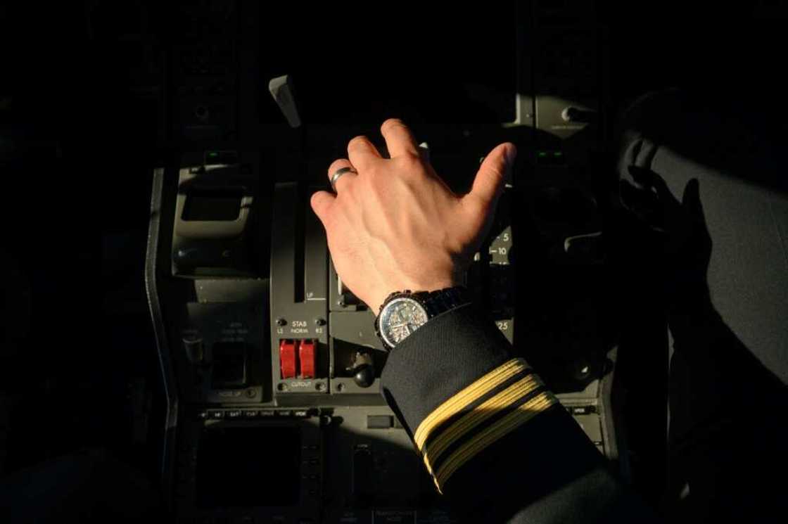 A pilot holds the thrust controls of a United Airlines Boeing 787 aircraft at Newark Liberty International Airport in Newark, New Jersey A pilot holds the thrust controls of a United Airlines Boeing 787 aircraft at Newark Liberty International Airport in Newark, New Jersey