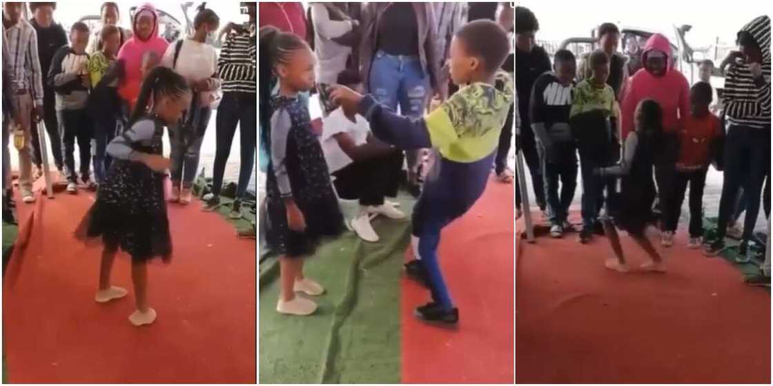 A boy and a girl engaged in a dancing competition A boy and a girl engaged in a dancing competition