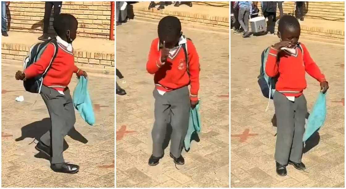 Black boy in red and grey school uniform dancing in school compound. Black boy in red and grey school uniform dancing in school compound.