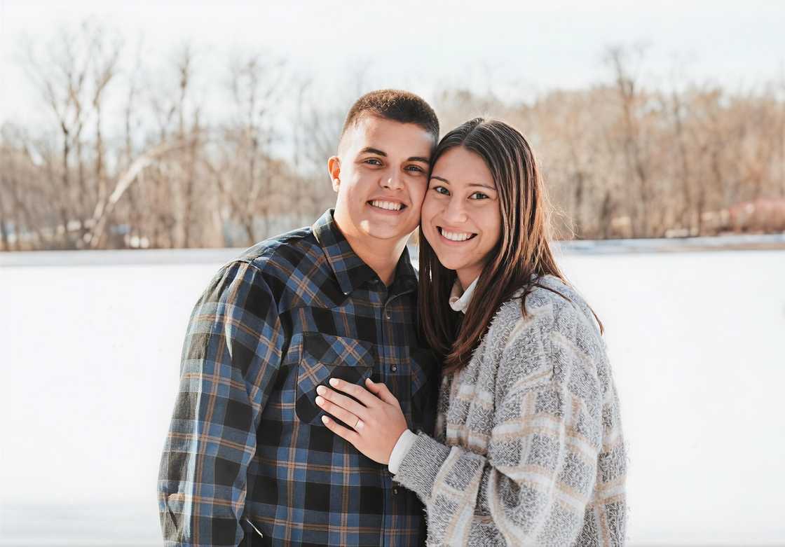 Aidan O'Connell and Jael posing for a photo besides a lake