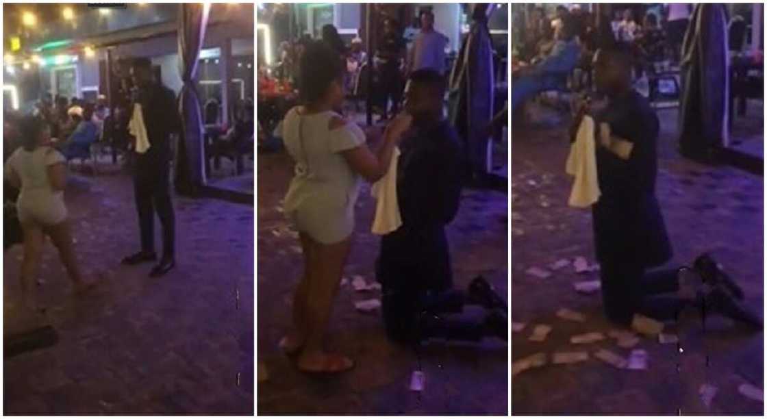 Nigerian girl sprays money as grown man kneels for her in viral video. Nigerian girl sprays money as grown man kneels for her in viral video.