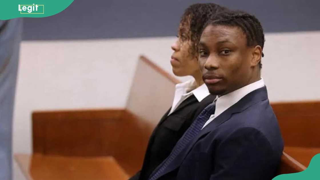 Henry Ruggs sits on a bench in a court Henry Ruggs sits on a bench in a court