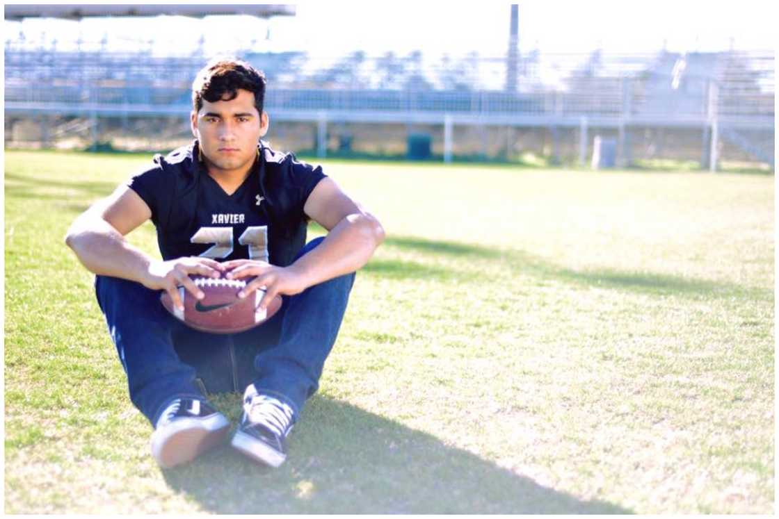 Isaac Ortega sitting on a baseball field