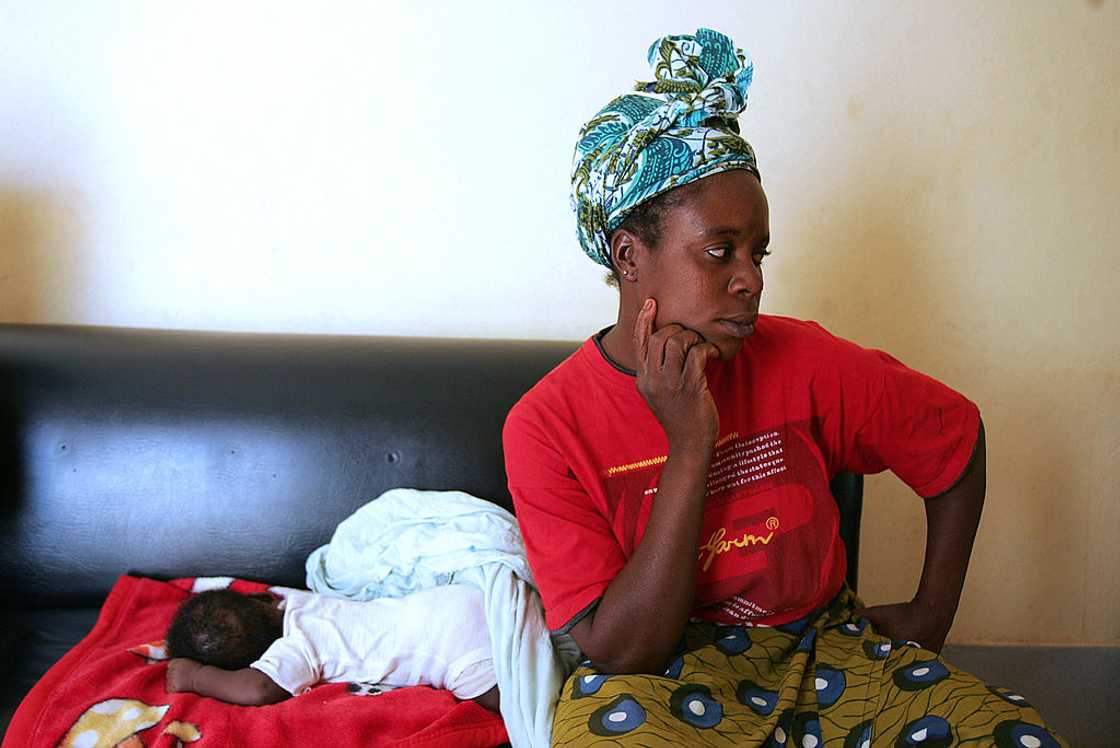 Mother sits on a chair with her baby. Mother sits on a chair with her baby.