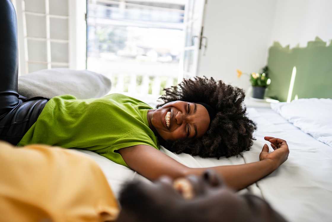 A couple lying down in bed talking A couple lying down in bed talking