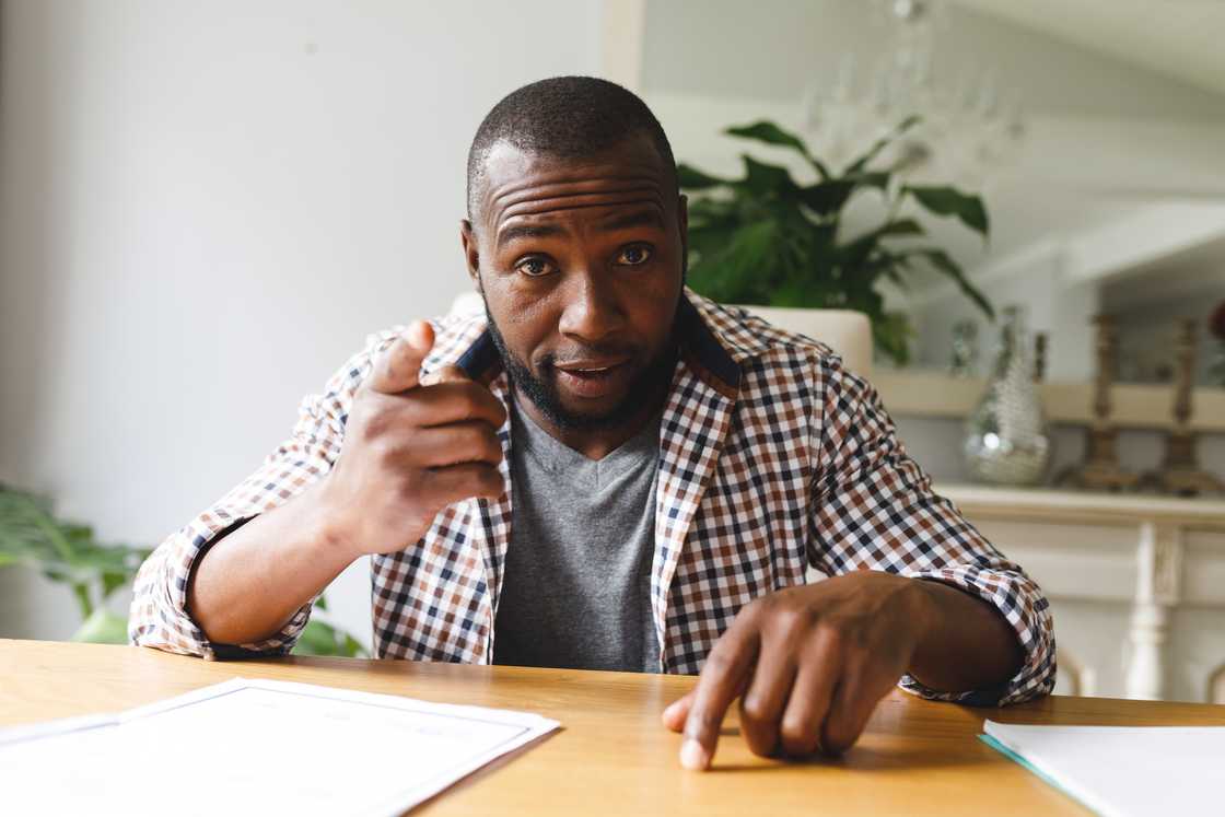A person slamming hand on kitchen table during tense argument.