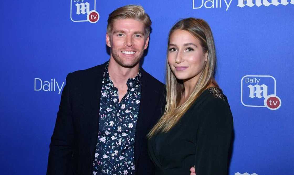 Kyle Cook (L) and Amanda Batula (R) posing for a photo