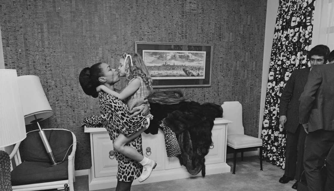 Eartha Kitt holding her daughter Kitt at the Carlton Towers Hotel