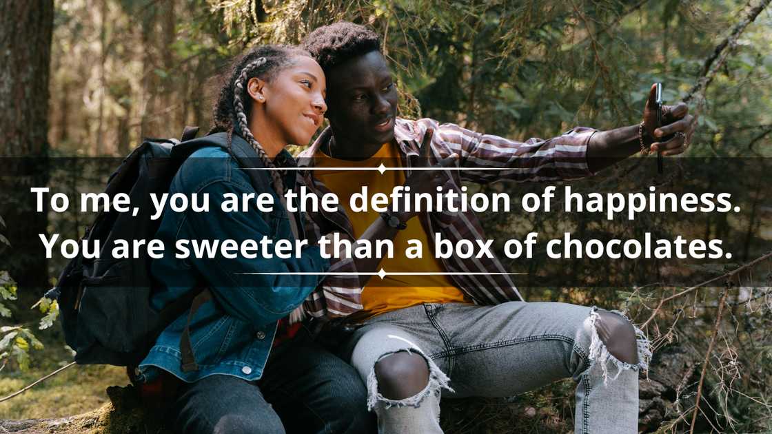 A young couple is taking a selfie in the woods A young couple is taking a selfie in the woods