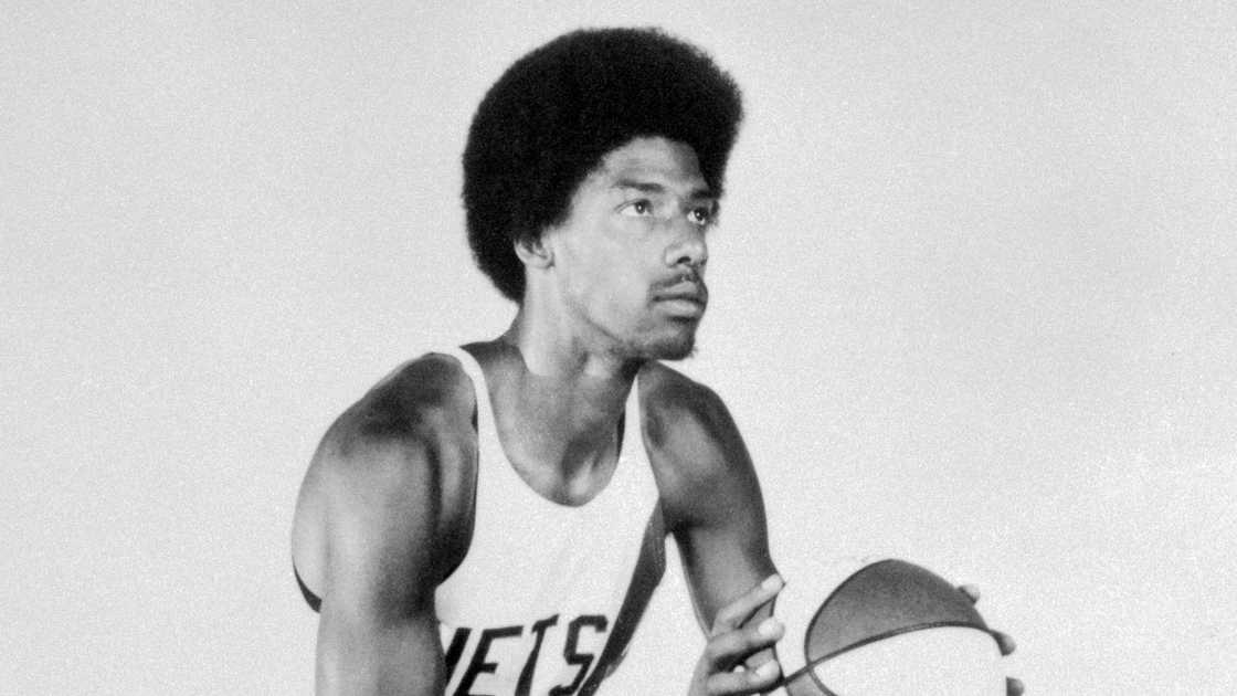 Julius Erving of the Brooklyn Nets pictured poised to dunk.