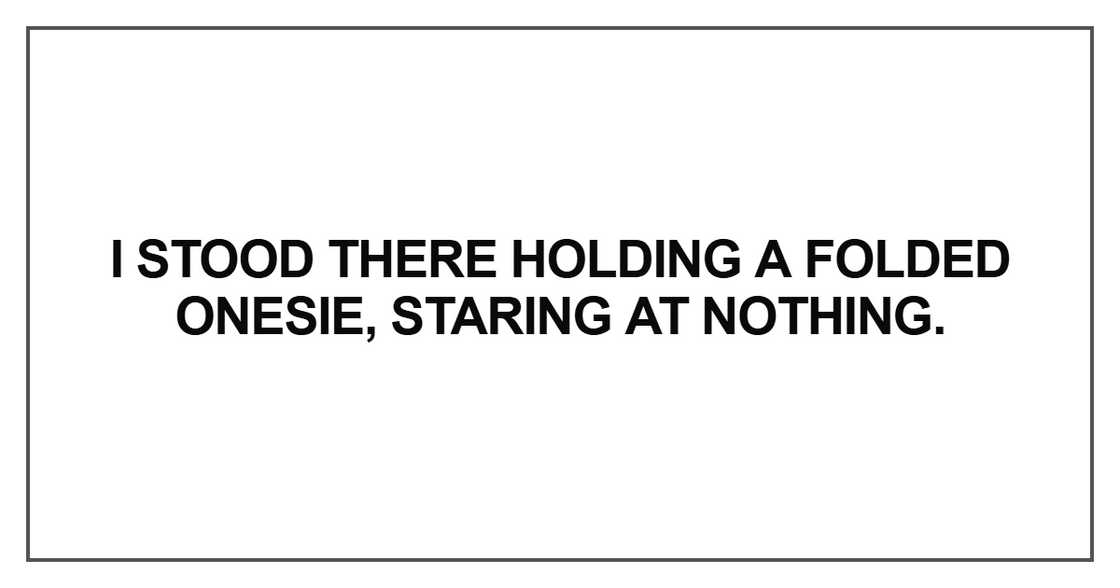 I stood there holding a folded onesie, staring