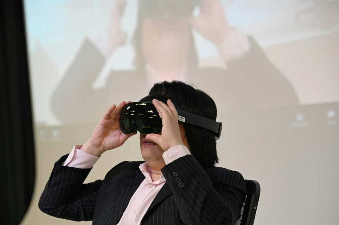 Pan Hui, a professor leading a project on AI education at the Hong Kong University of Science and Technology, slips on a headset