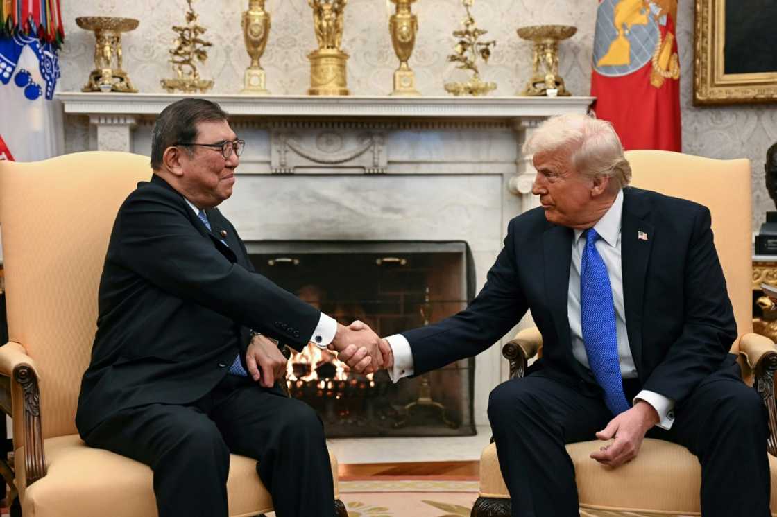 US President Donald Trump shakes hands with with Japanese Prime Minister Shigeru Ishiba in the Oval Office of the White House in Washington, DC, on February 7, 2025.