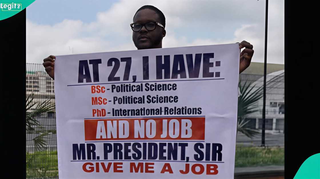 A man with a PhD protests unemployment after struggling to get a job A man with a PhD protests unemployment after struggling to get a job