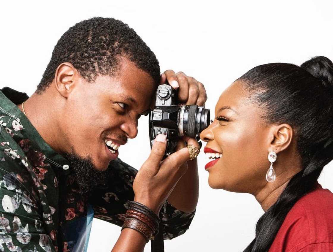 Remi Adetiba posing with a camera during a photo shoot with Kemi Adetiba