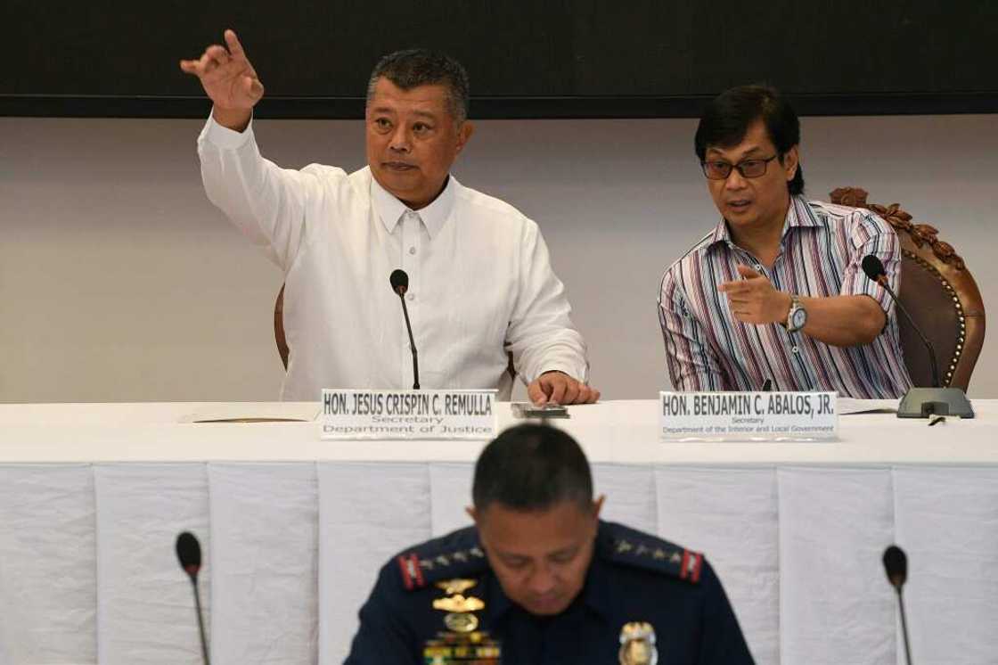 Philippine officials, pictured, give a press conference announcing that the country's prisons chief is accused of a journalist's murder Philippine officials, pictured, give a press conference announcing that the country's prisons chief is accused of a journalist's murder