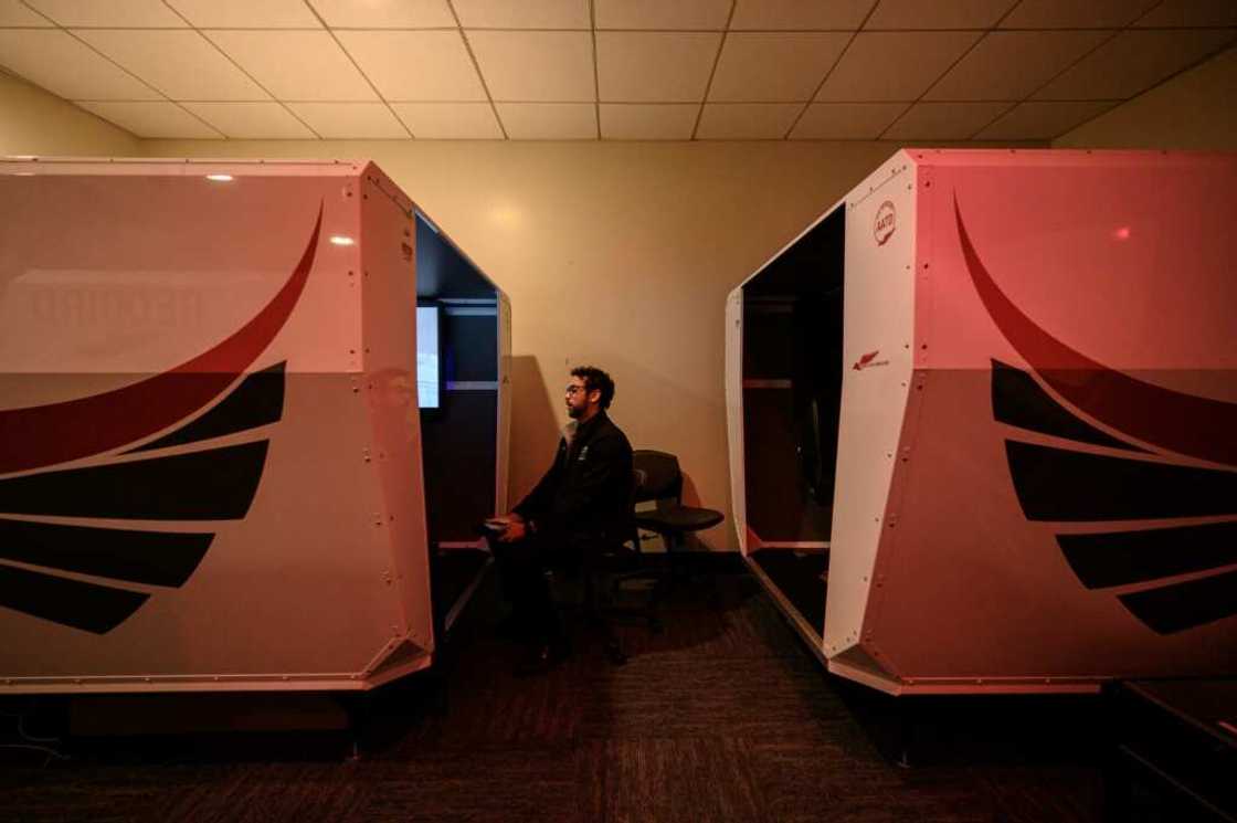 An instructor watches as a student pilot undergoes a training session in a flight simulator at the Farmingdale State College in Farmingdale, New York An instructor watches as a student pilot undergoes a training session in a flight simulator at the Farmingdale State College in Farmingdale, New York