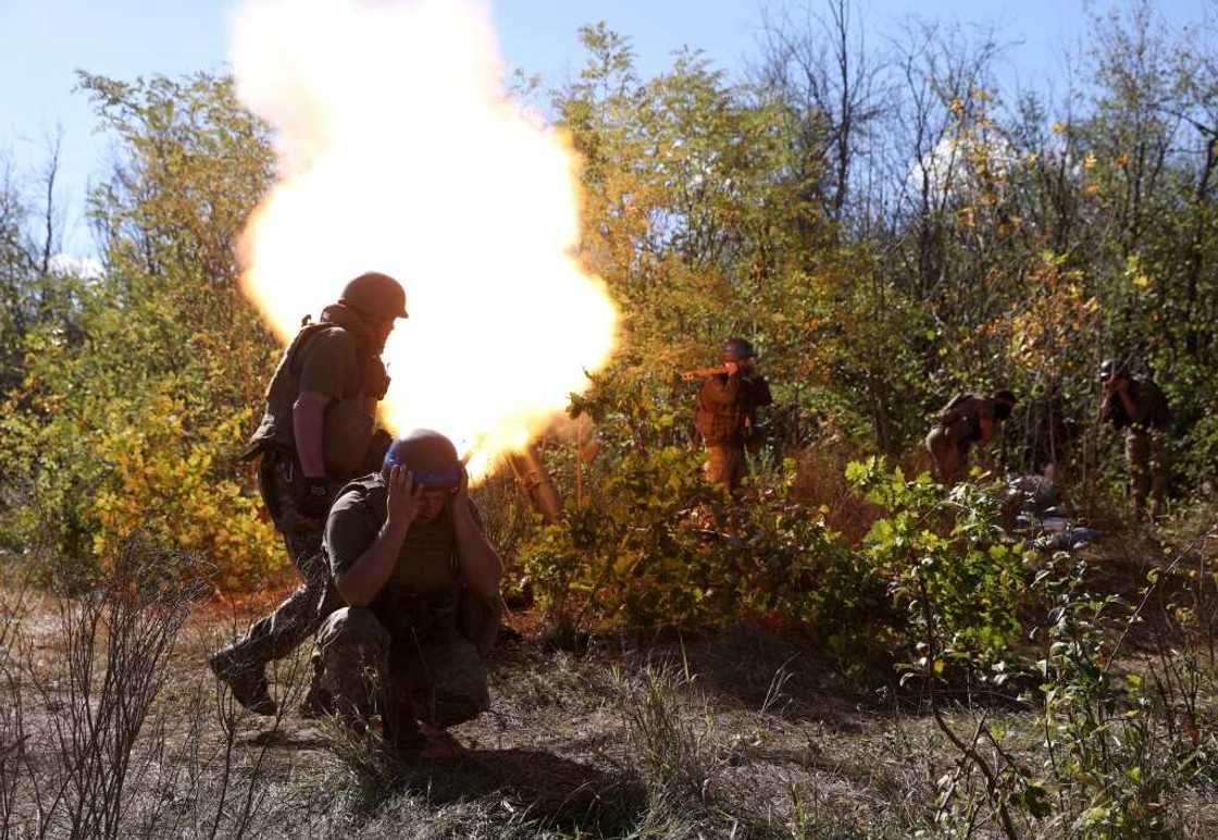 Ukrainian servicemen fire a mortar from their position on the front line with Russian troops in Donetsk Ukrainian servicemen fire a mortar from their position on the front line with Russian troops in Donetsk