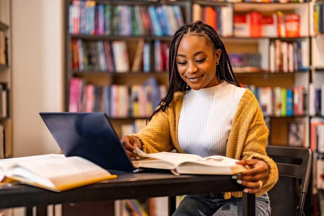 A young lady studying in a library A young lady studying in a library