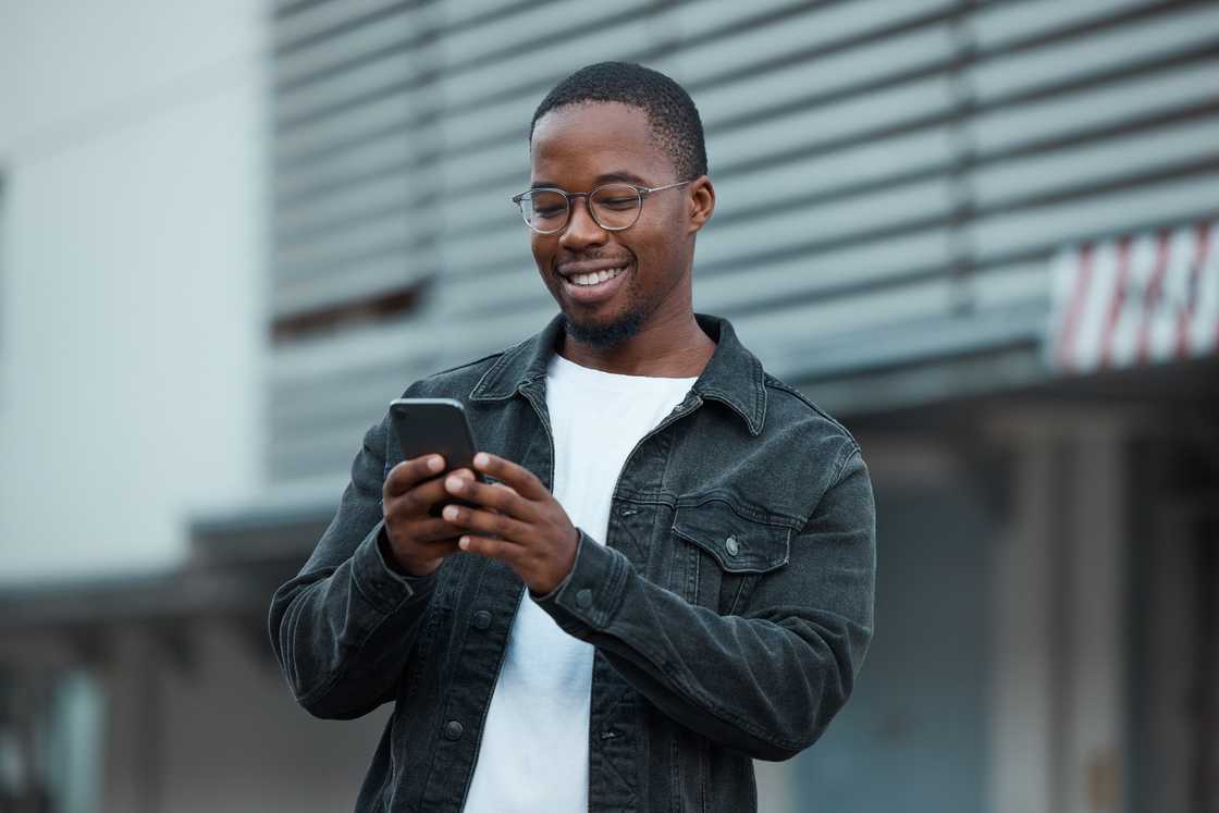 A guy texting on his phone. A guy texting on his phone.