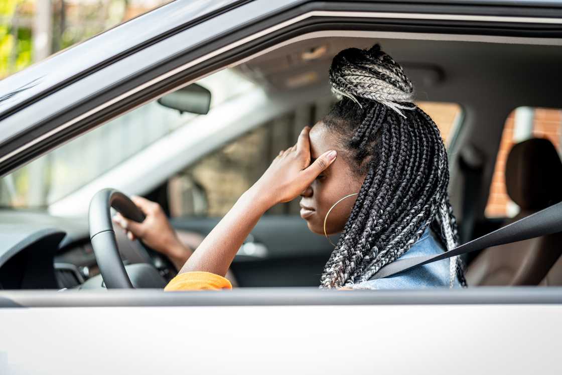 A frustrated woman in a car