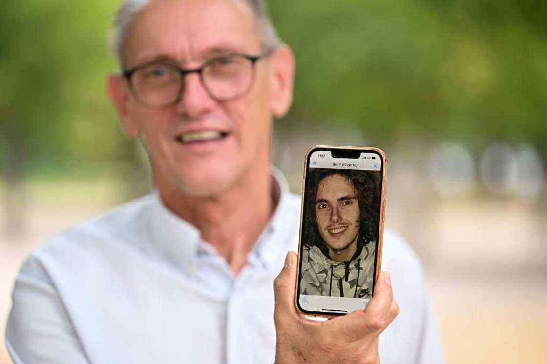 Paul Raoult, the father of Sebastien Raoult, shows a picture of his son on his phone