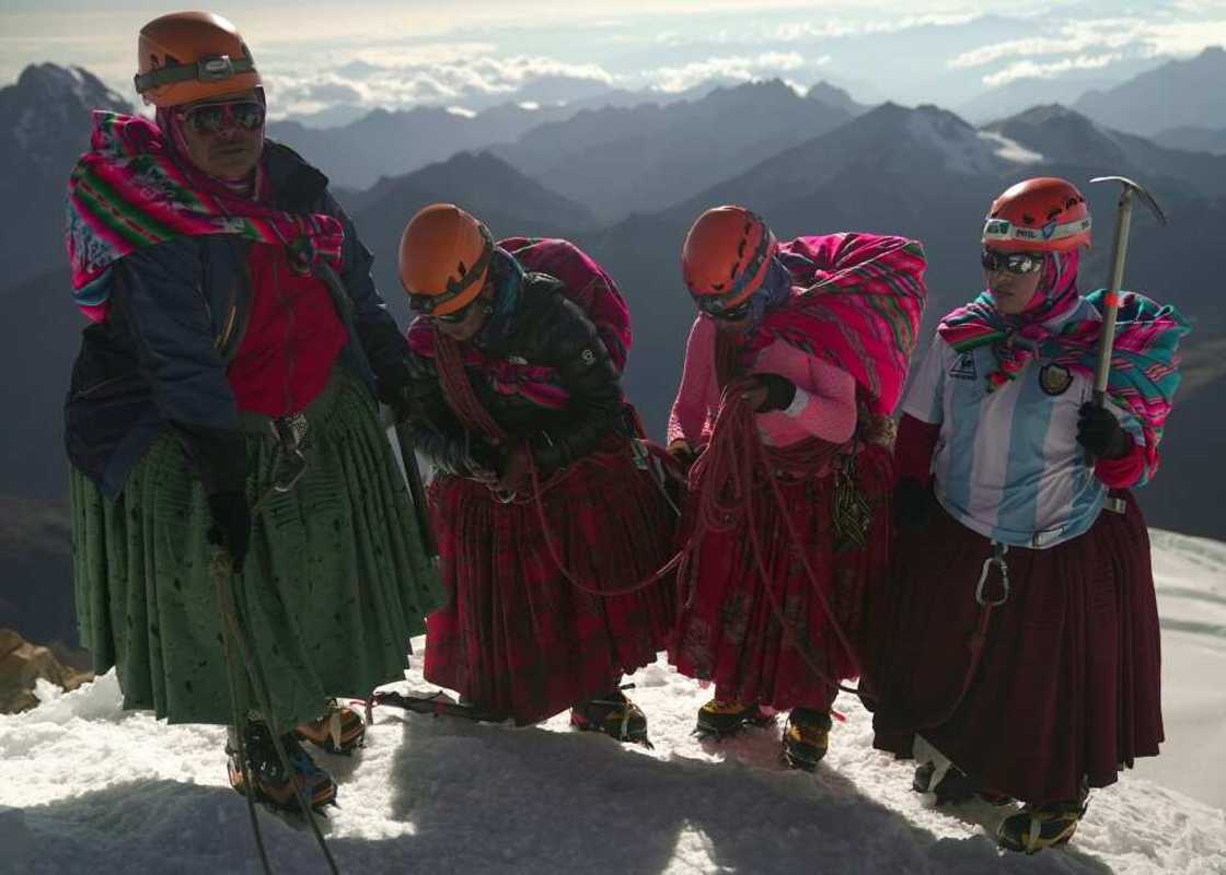 (Left-right) Adela Llusco, Senobia Llusco, Cecilia Llusco and Camila Tarqui Llusco, Aymara indigenous women members of the Climbing Cholitas of Bolivia Warmis, at the summit of the 6.088-metre Huayna Potosi mountain (Left-right) Adela Llusco, Senobia Llusco, Cecilia Llusco and Camila Tarqui Llusco, Aymara indigenous women members of the Climbing Cholitas of Bolivia Warmis, at the summit of the 6.088-metre Huayna Potosi mountain