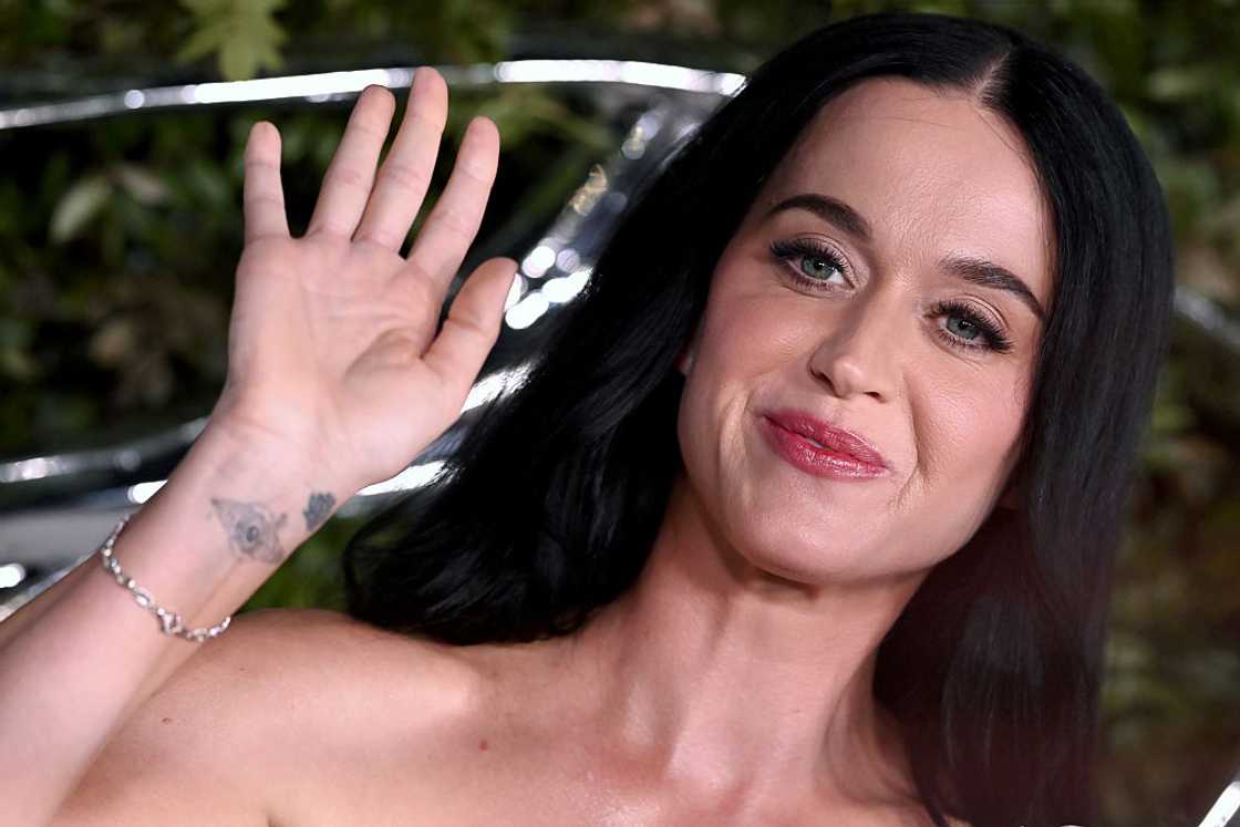 Katy Perry waving her hand at an event Katy Perry waving her hand at an event