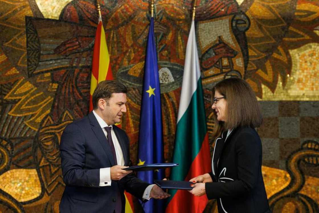 Bulgarian Foreign Minister Teodora Genchovska and her North Macedonian counterpart Bujar Osmani exchange a signed deal in Sofia Bulgarian Foreign Minister Teodora Genchovska and her North Macedonian counterpart Bujar Osmani exchange a signed deal in Sofia